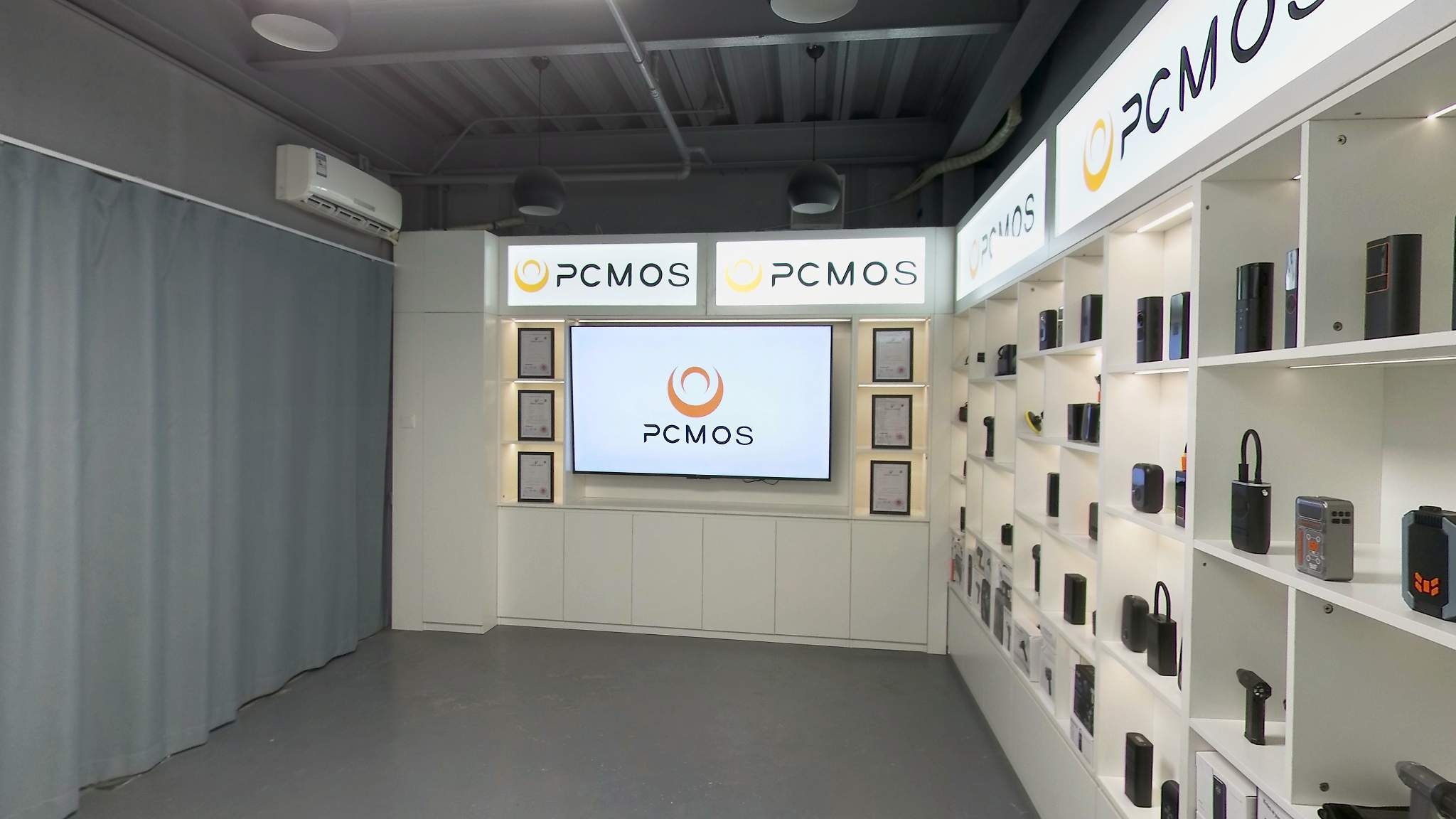 PCMOS Guangzhou showroom with brand wall and automotive electronics samples
